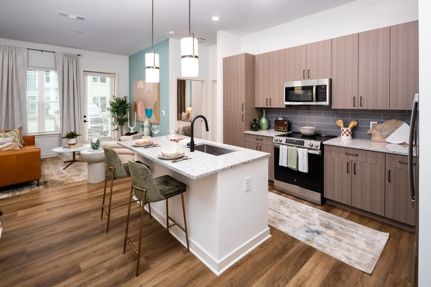 Open-concept kitchen and living room with granite island at Everhill Kennesaw apartments in Marietta