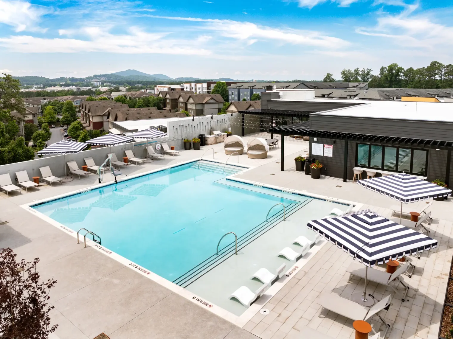 Elevated view of the rooftop pool and outdoor lounge areas at Everhill Kennesaw apartments in Marietta, GA