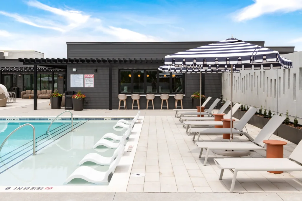 Rooftop pool deck with lounge chairs and shaded seating at Everhill Kennesaw apartments